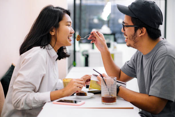 istock asian couple having fun together at a coffee shop 1023848236