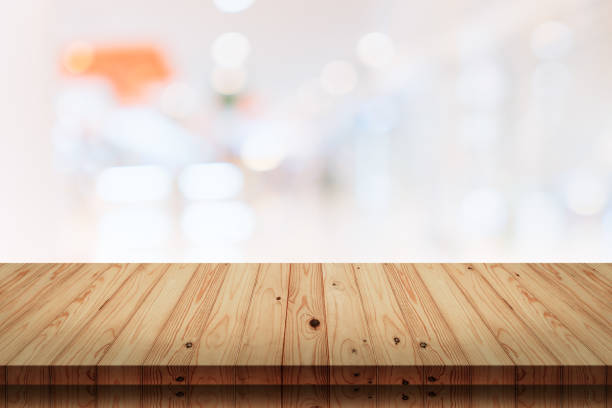 istock Empty wooden table with blur shopping mall background. 1023850816
