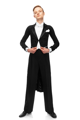 young ballroom dancer dressed in a tailcoat on white background