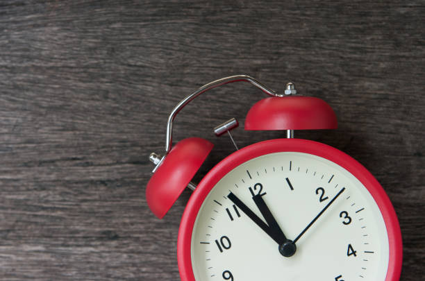 istock Red alarm clock on wooden background and coppy space 1023867676