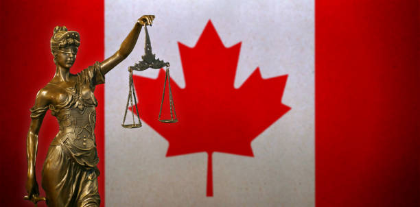 istock Lady Justice before a Canadian flag 1023867862
