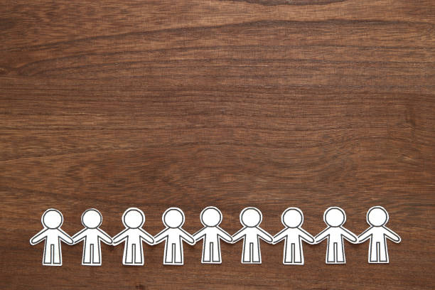 istock Group of people holding hands on wood.  Teamwork concept. Social Network concept. 1023872402