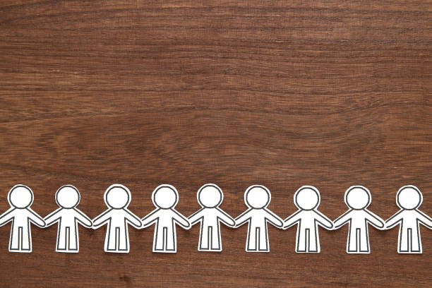 istock Group of people holding hands on wood.  Teamwork concept. Social Network concept. 1023872404