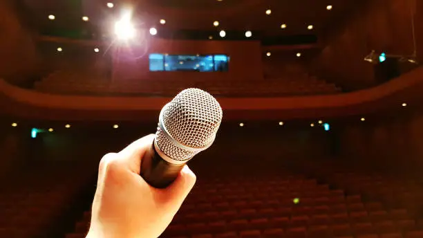 A microphone on stage inside a theater without anyone
