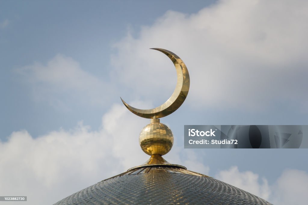 Islamic moon - the sign on the mosque Islamic moon - the sign on the mosque n front of sunny day sky Islam Stock Photo