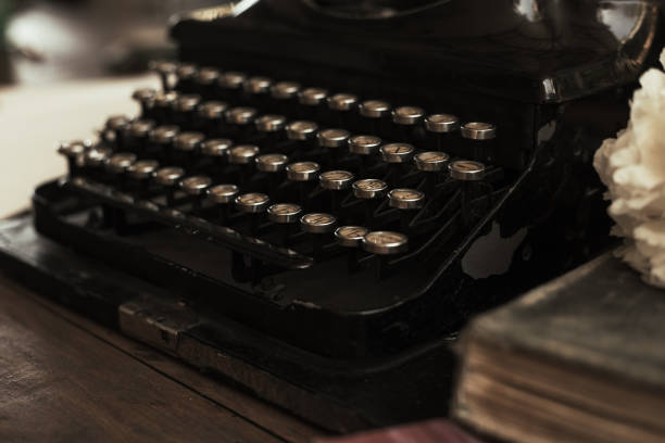 istock Old black typewriter with paper worth on the table 1023892020