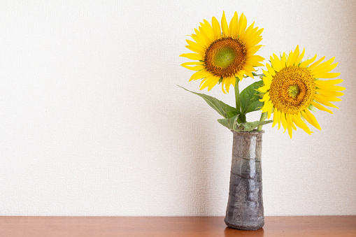 It is a yellow sunflower flower decorated in the room.