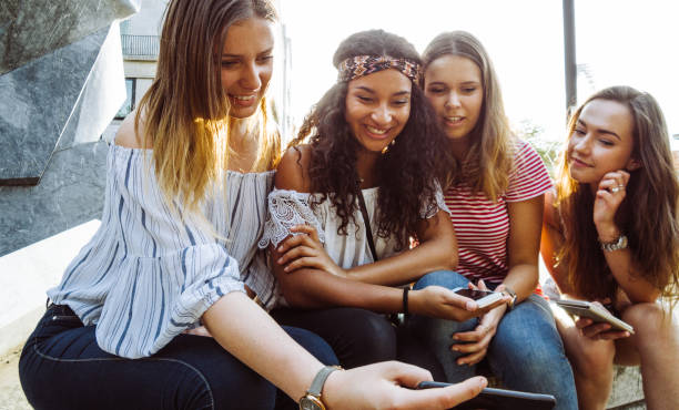 istock teens using the smartphone in the city 1023919896