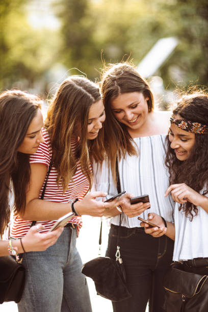 istock teens using the smartphone in the city 1023919962