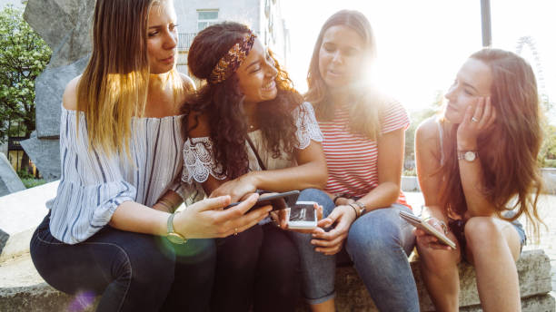 istock teens using the smartphone in the city 1023920022