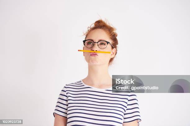 Bored Woman Having Fun With Pencil Stock Photo - Download Image Now - Contemplation, Women, Teenager