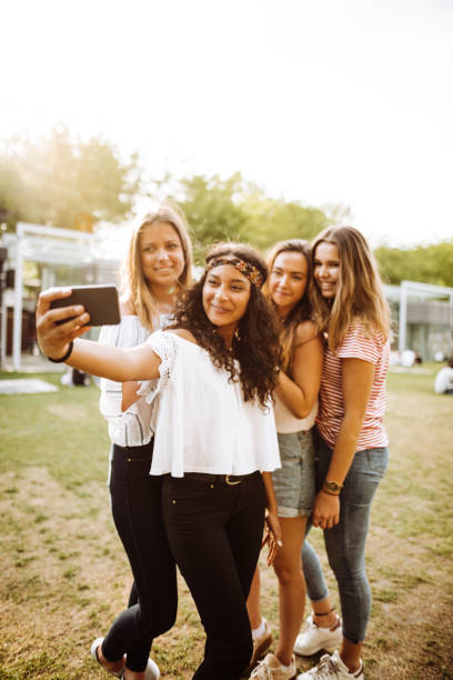 istock friends take a selfie in the park 1023925620