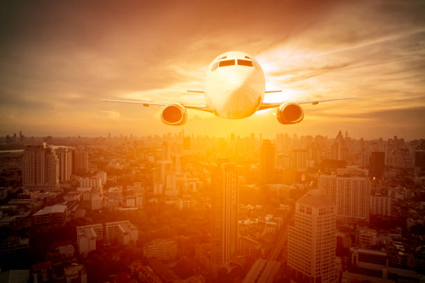istock Aircraft fly over cityscape and modern buildings 1023925804