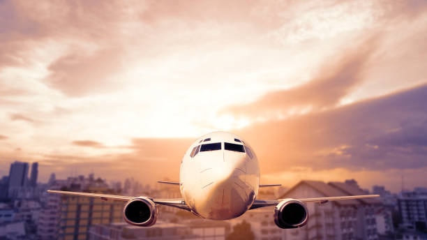 istock Aircraft fly over cityscape and modern buildings 1023925820