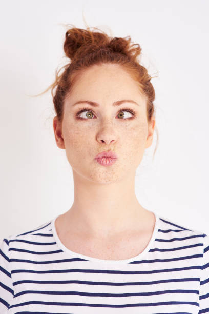 istock Cross eyed girl making a face at studio shot 1023927962