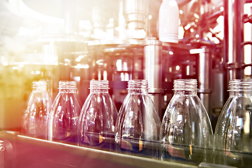 Line of bottling beverages in plastic bottles on factory
