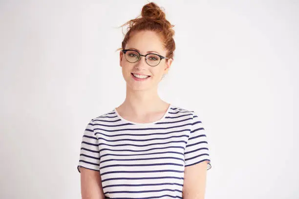 Portrait of young woman with glasses at studio shot