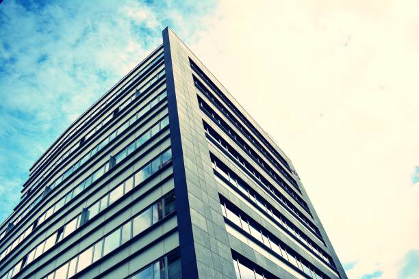 istock Modern office building on a clear sky background. Retro stylized colorful tonal filter effect 1023933212