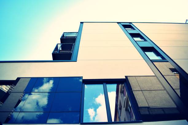 istock Modern office building on a clear sky background. Retro stylized colorful tonal filter effect 1023933578