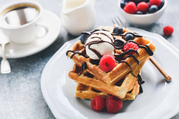 istock Belgian waffles with berries, ice cream and chocolate sauce 1023939518