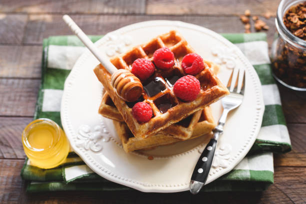 istock Belgian waffles with raspberries and honey 1023939522