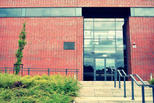 istock Modern office building on a clear sky background. Retro stylized colorful tonal filter effect 1023942940