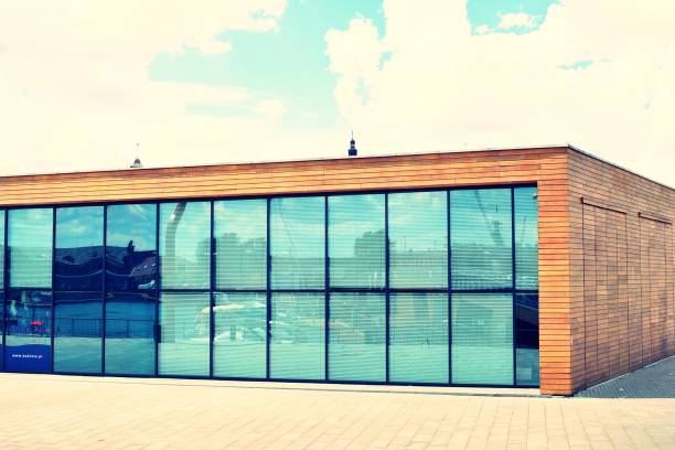 istock Modern office building on a clear sky background. Retro stylized colorful tonal filter effect 1023945496