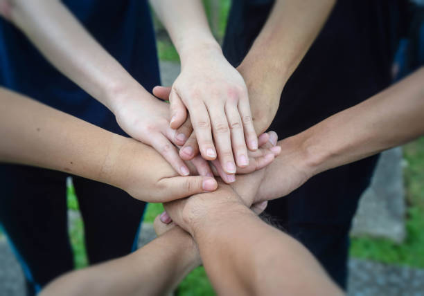 istock Business team standing and stack their hands together people joining for cooperation success business. Teamwork concept 1023946036