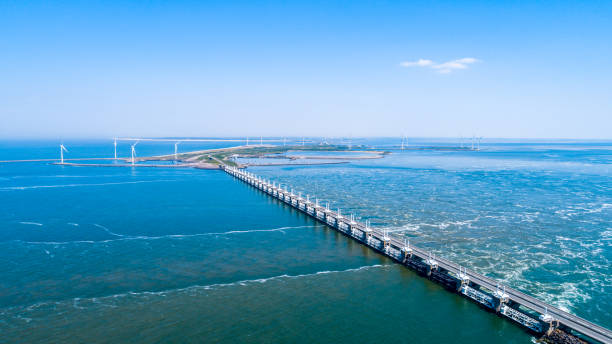 Oosterschelde flood barrier at the Northern Sea in Zeeland the Netherlands from above Oosterschelde flood barrier with windmills in the Netherlands at the Northern Sea taken from above with a drone netherlands aerial stock pictures, royalty-free photos & images