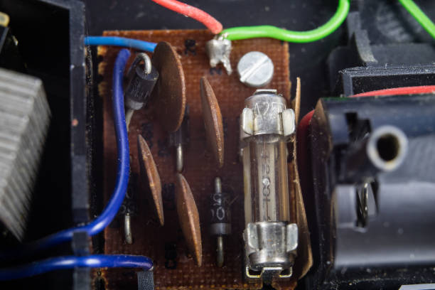 Old integrated circuits in an analog radio receiver. Resistors, transistors and other circuits on an old integrated circuit board. Workplace - workshop.