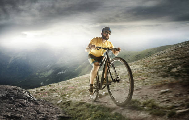 istock The young fit men in helmet conquering mountains on a bicycle 1023959638