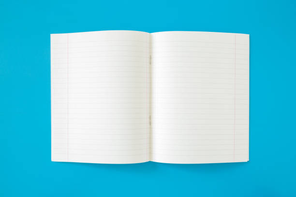 istock Opened white lined exercise book on the blue work table. Empty place for daily plans, important information, ideas, memories or other text. Top view. Flat lay. 1023959752