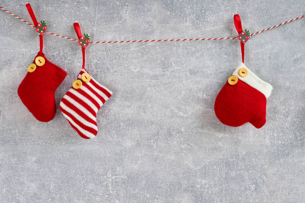istock Christmas background. Red Christmas socks and mitten on gray background. Copy space. 1023976394