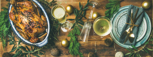 istock Holiday celebration table setting over rustic wooden background, wide composition 1023976400