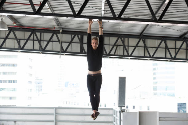 istock Young handsome man hanging on the steel frame 1023980924