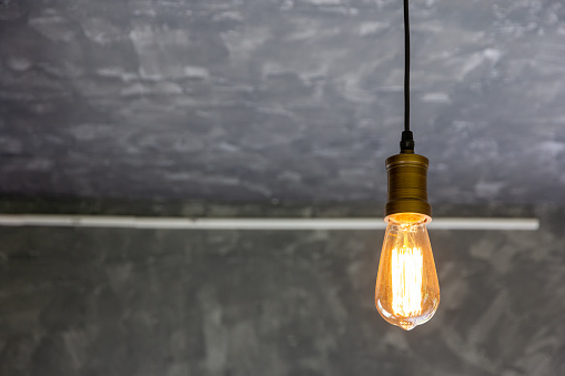 lighting lamp hang hanging from the ceiling grey cement background