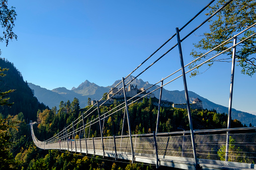 People walking on the Highline179, a suspension footbridge extending at an altitude of 114 meters (374 ft) and connecting the Ehrenburg castle ruins with Fort Claudia. It is located near Reutte, Austria, on the Bavarian-Austrian Border.