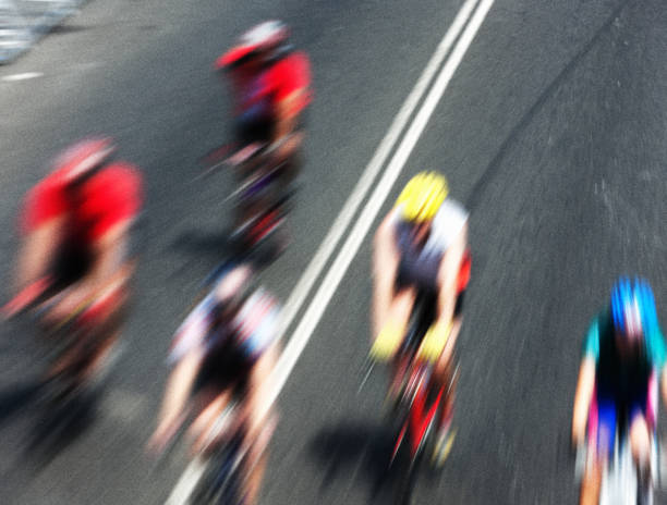 istock Group of cyclists race past at high speed 1023988486