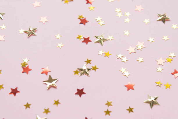 istock Various sparkly sequins stars on a pink background. 1024000626