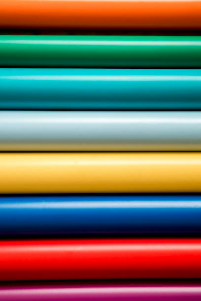 Colorful vinyl rolls on wooden background with your necessary instruments