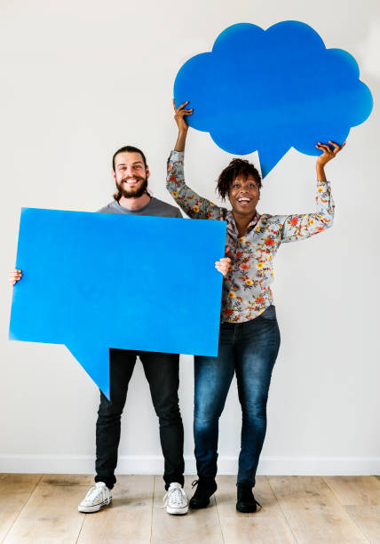 istock Happy interracial couple holding copy space speech bubble 1024003388