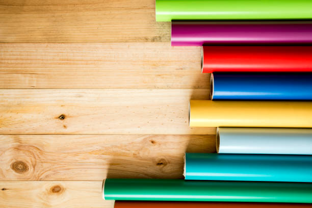 Colorful vinyl rolls on wooden background