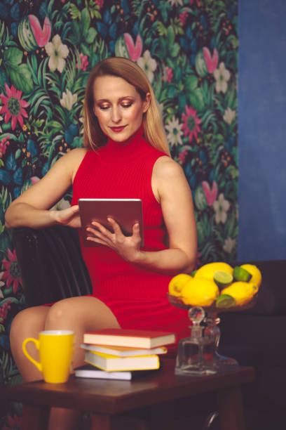 istock Beautiful woman is browsing the internet at home 1024003948