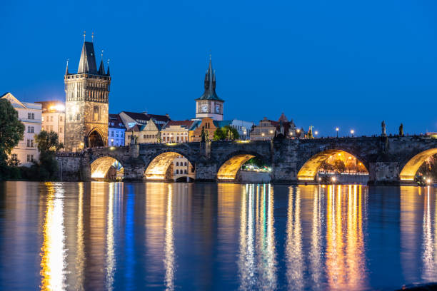 istock Illuminated Charles Bridge reflected in Vltava River. Evening in Prague, Czech Republic 1024004160