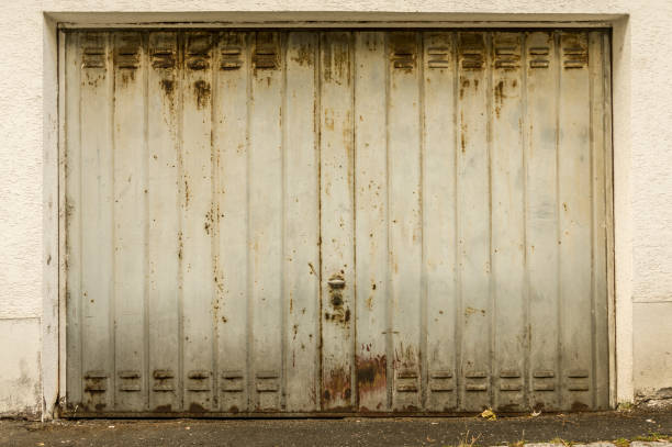 old, light gray and rusty garage door in vintage look