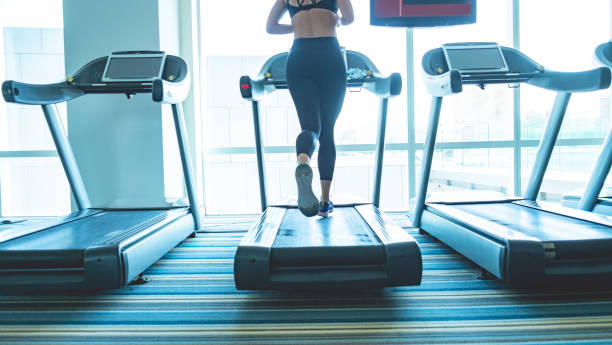 istock Young woman running in gym 1024009042