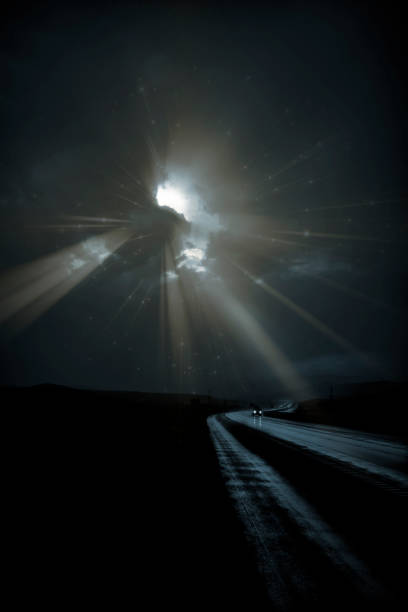 istock Single car travels on dark road 1024009560