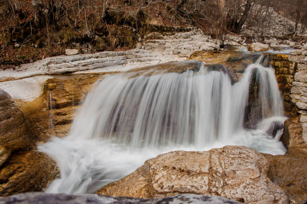 istock Majestic tiny waterfall on the mountain river among the rocks 1024017354