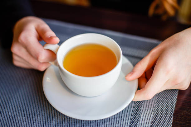 istock Women's hands holding a Cup of green tea 1024024810