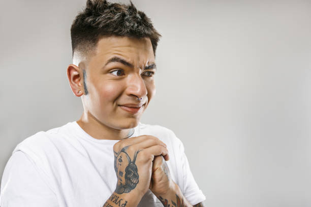 istock Young man with disgusted expression repulsing something, isolated on the gray 1024029518